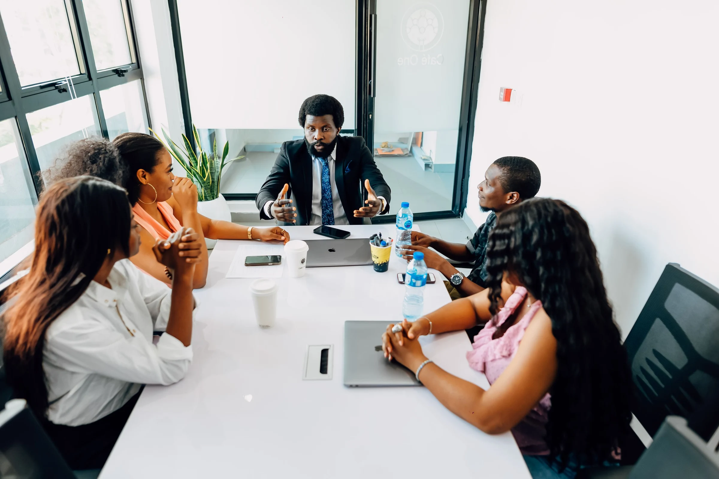 Colleagues sharing a conversation around a table in a Lagos office