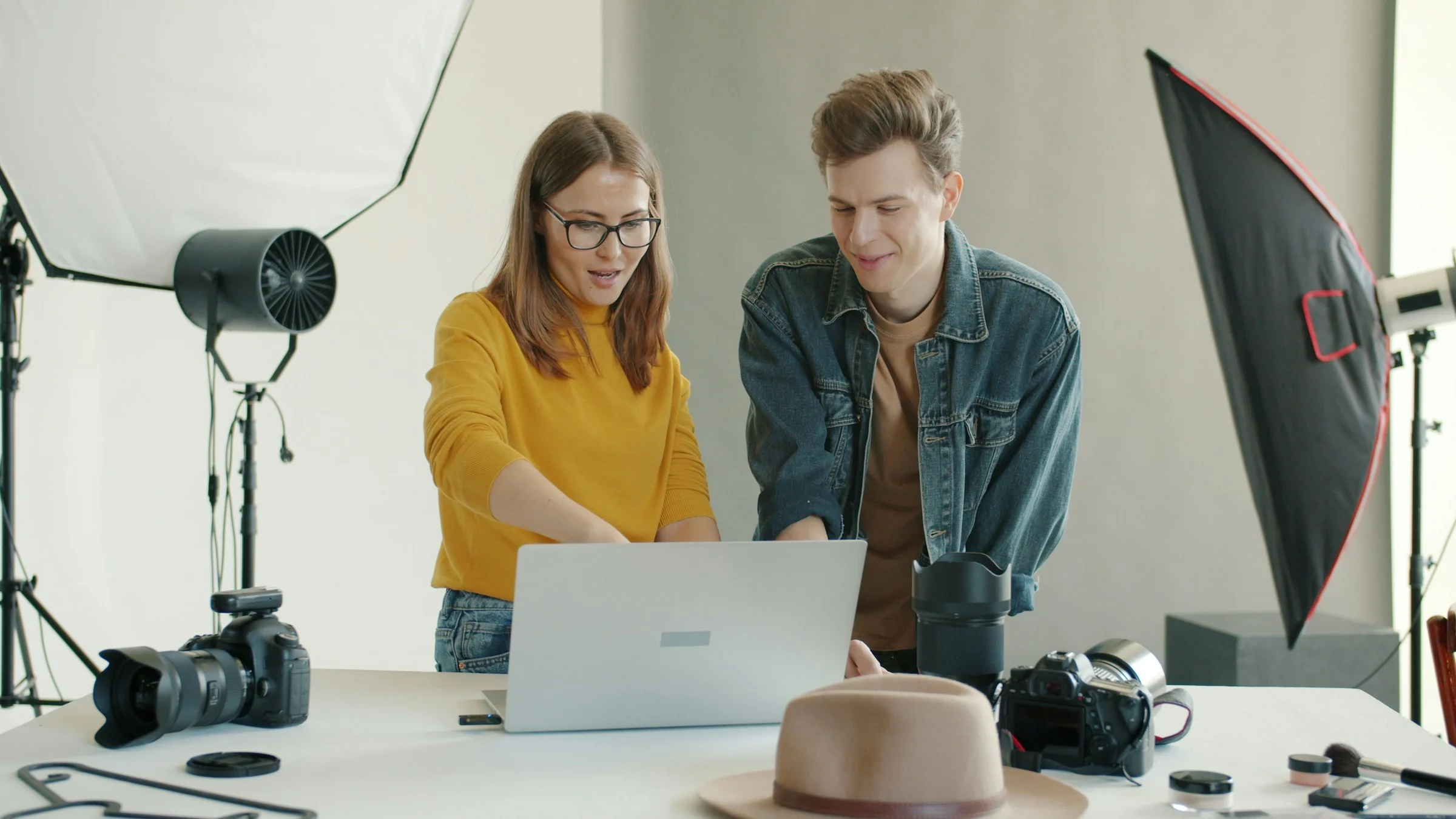 Creators collaborating at a laptop