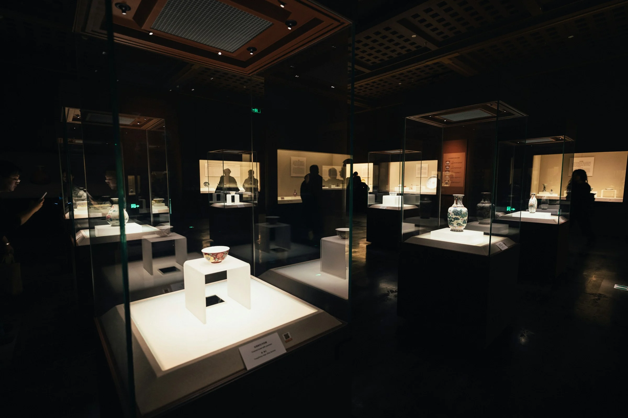 Museum objects displayed in illuminated glass cases