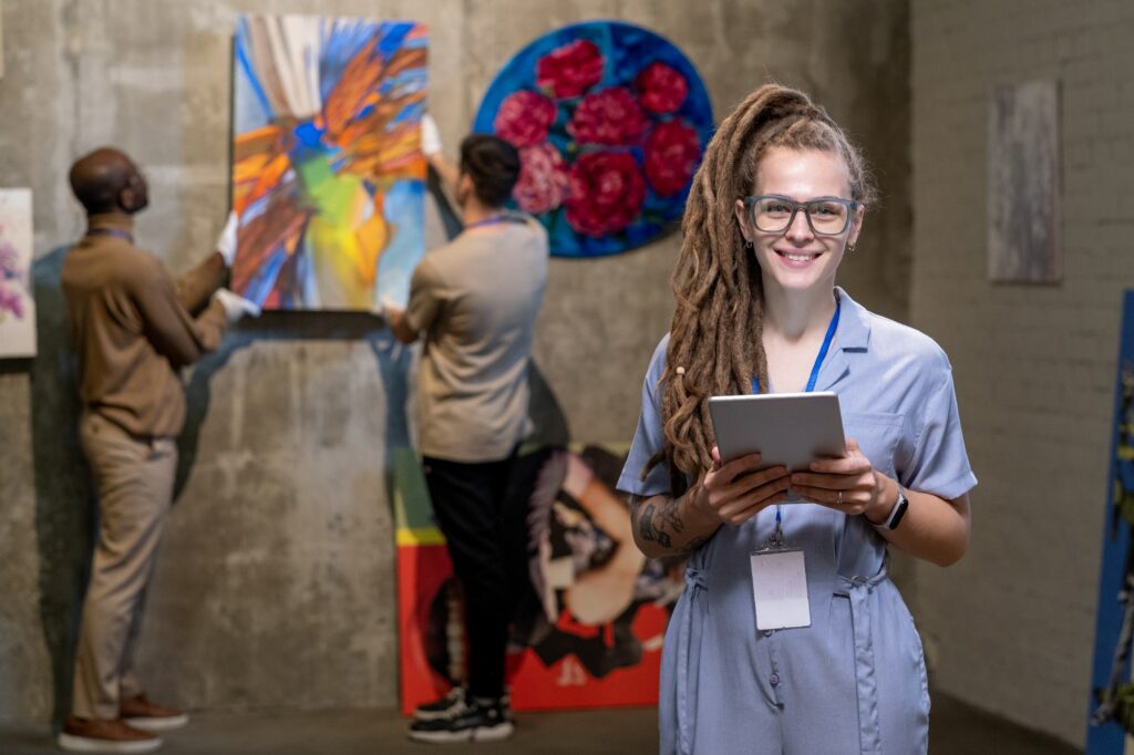 Woman arranging exhibition in art gallery