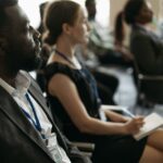A diverse group of professionals attentively listening at a conference seminar.